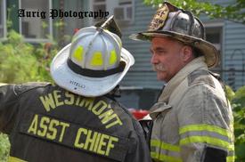 July 30, 2012: Elgin Avenue All-Hands fire. Assistant Chief Mike Vitelli discusses the fire with Chief John Medes. (copyright Ted Auring)